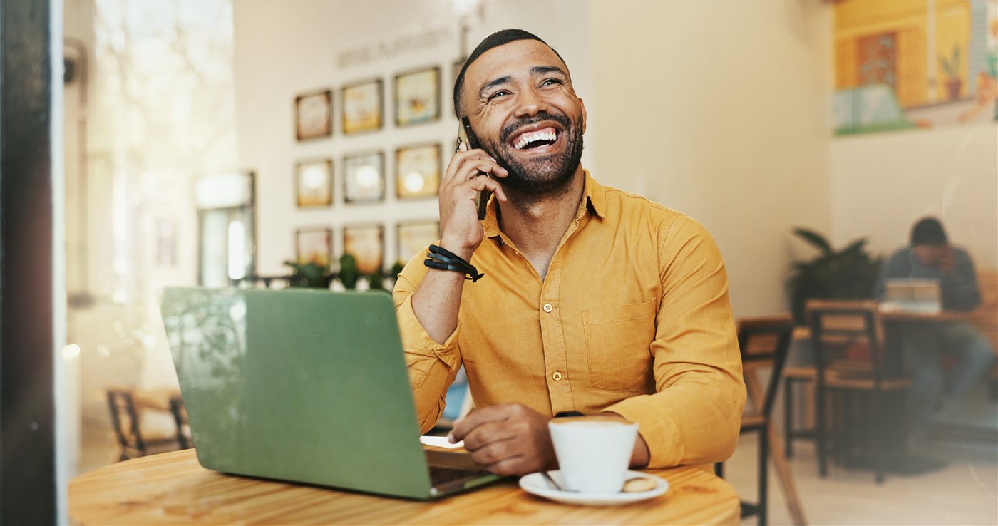 Confident business owner working on a laptop